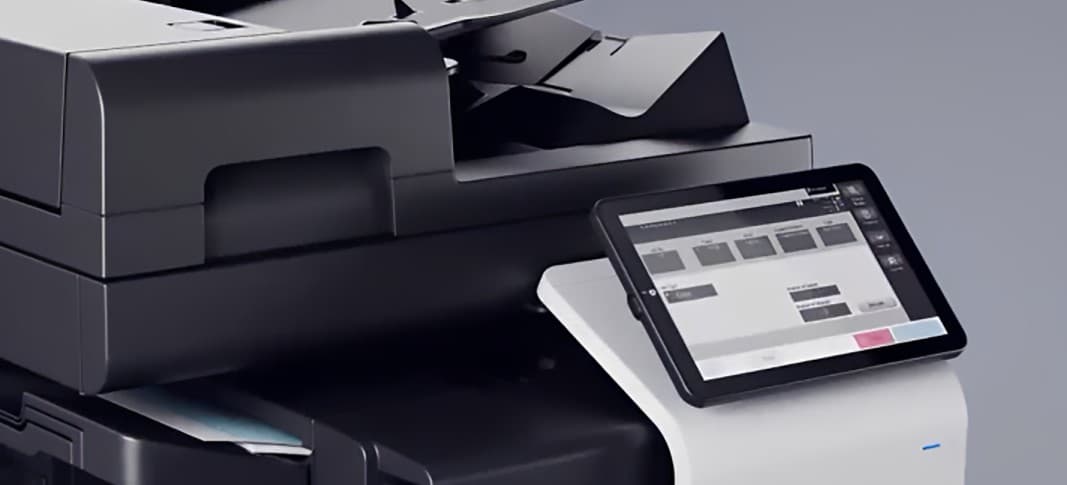 Close-up of a multifunction office printer with its touchscreen control panel